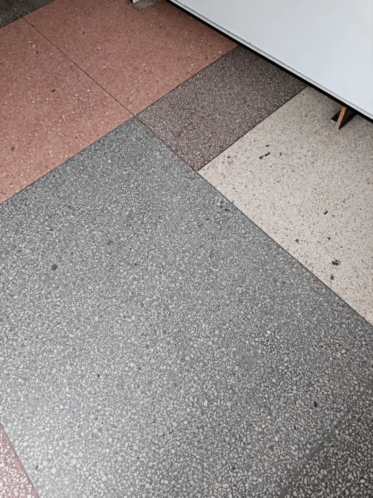 Terrazzo floor with speckled sections in grey, pink, brown and cream