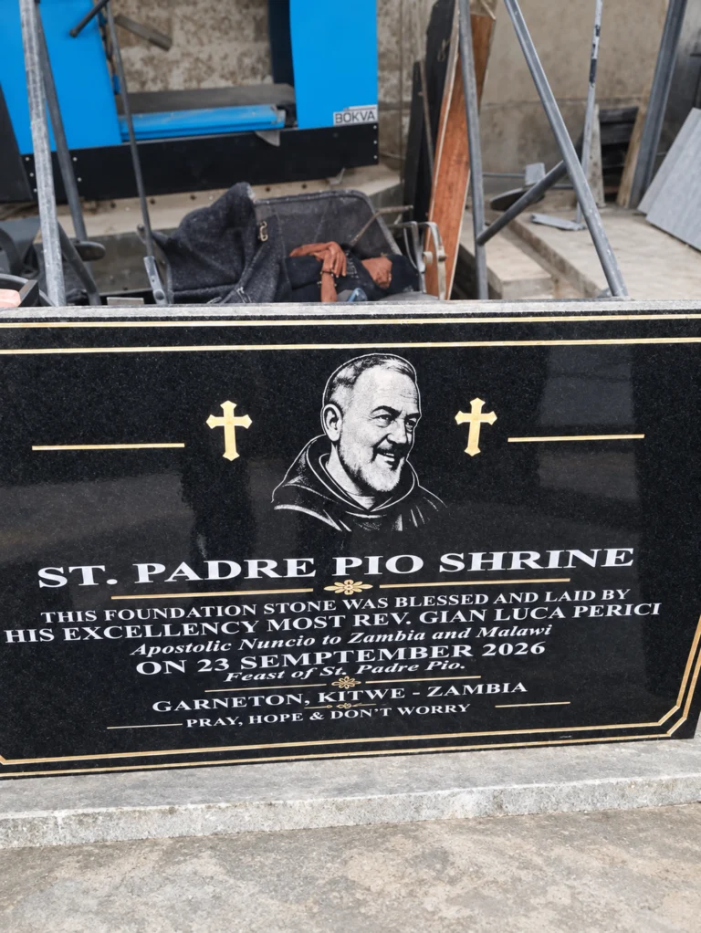 Black granite foundation stone plaque with an engraved portrait, gold crosses and gold border lines