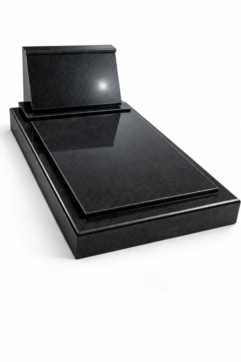 Inclined black granite headstone on a polished black ledger with rounded edges